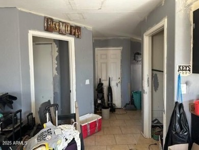 Investor special! Spacious 5-bedroom, 2.5-bath fixer-upper on Oasis Golf Club in Arizona - for sale on GolfHomes.com, golf home, golf lot