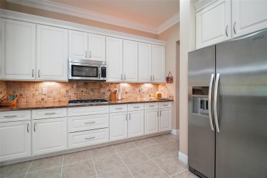 This pristine, expanded Hampton shows pride in ownership at on Eagle Ridge At Spruce Creek Country Club in Florida - for sale on GolfHomes.com, golf home, golf lot