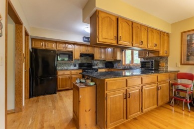 This is a home that checks all the boxes. Inside is a large well on Merrill Golf Club in Wisconsin - for sale on GolfHomes.com, golf home, golf lot