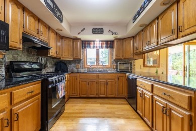 This is a home that checks all the boxes. Inside is a large well on Merrill Golf Club in Wisconsin - for sale on GolfHomes.com, golf home, golf lot