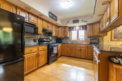 This is a home that checks all the boxes. Inside is a large well on Merrill Golf Club in Wisconsin - for sale on GolfHomes.com, golf home, golf lot