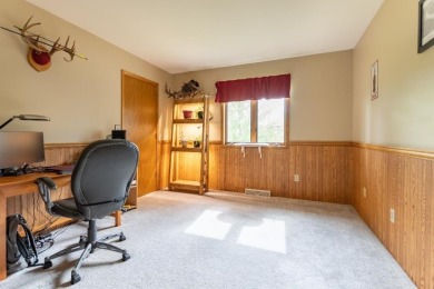 This is a home that checks all the boxes. Inside is a large well on Merrill Golf Club in Wisconsin - for sale on GolfHomes.com, golf home, golf lot
