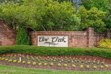 Experience coastal living at its finest in this meticulously on Crow Creek Golf Club in North Carolina - for sale on GolfHomes.com, golf home, golf lot