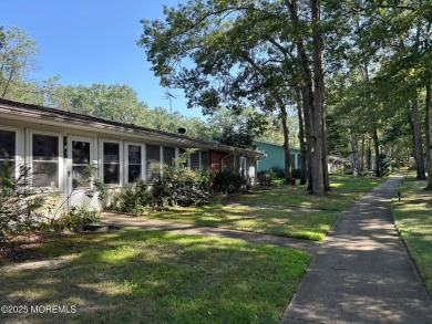 A Greenbriar model where access to the front door entrance is on Greenbriar Woodlands in New Jersey - for sale on GolfHomes.com, golf home, golf lot