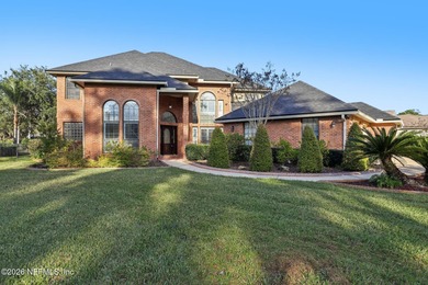 All brick two-story Eagle Harbor home with pond and fairway on Eagle Harbor Golf Club in Florida - for sale on GolfHomes.com, golf home, golf lot