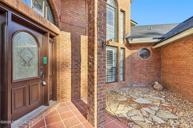 All brick two-story Eagle Harbor home with pond and fairway on Eagle Harbor Golf Club in Florida - for sale on GolfHomes.com, golf home, golf lot