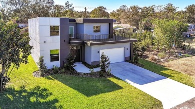 Welcome to this stunning 5-bedroom, 5.5-bathroom CONTEMPORARY on Temple Terrace Golf and Country Club in Florida - for sale on GolfHomes.com, golf home, golf lot