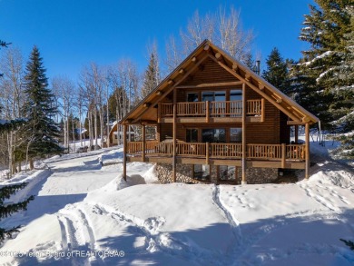 This stunning custom log home on Hole #1 of Aspen Hills Golf on Star Valley RV Golf Course in Wyoming - for sale on GolfHomes.com, golf home, golf lot