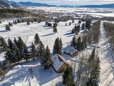 This stunning custom log home on Hole #1 of Aspen Hills Golf on Star Valley RV Golf Course in Wyoming - for sale on GolfHomes.com, golf home, golf lot