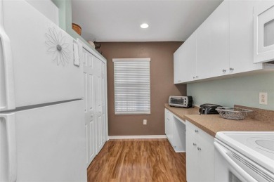 Discover this immaculate 2-bedroom, 2-bath condo with a den on Sabal Trace Golf and Country Club in Florida - for sale on GolfHomes.com, golf home, golf lot