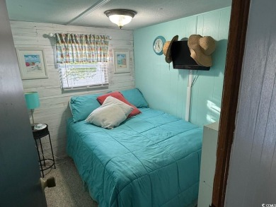 This cozy 2 bed, 1 bath furnished mobile home in the Waterway on Barefoot Resort and Golf Club  in South Carolina - for sale on GolfHomes.com, golf home, golf lot