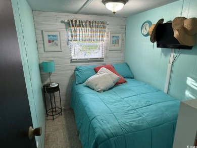 This cozy 2 bed, 1 bath furnished mobile home in the Waterway on Barefoot Resort and Golf Club  in South Carolina - for sale on GolfHomes.com, golf home, golf lot