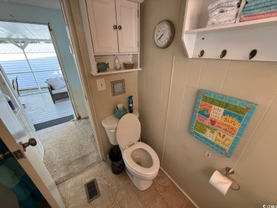This cozy 2 bed, 1 bath furnished mobile home in the Waterway on Barefoot Resort and Golf Club  in South Carolina - for sale on GolfHomes.com, golf home, golf lot