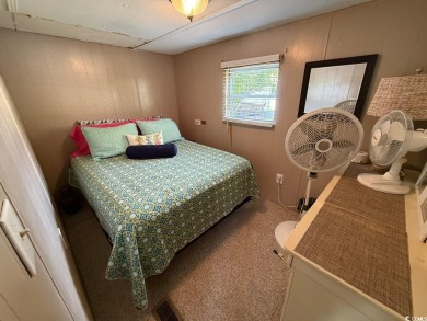 This cozy 2 bed, 1 bath furnished mobile home in the Waterway on Barefoot Resort and Golf Club  in South Carolina - for sale on GolfHomes.com, golf home, golf lot