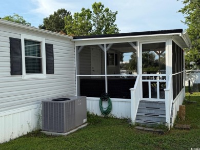 This cozy 2 bed, 1 bath furnished mobile home in the Waterway on Barefoot Resort and Golf Club  in South Carolina - for sale on GolfHomes.com, golf home, golf lot
