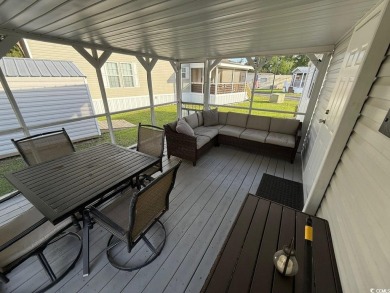 This cozy 2 bed, 1 bath furnished mobile home in the Waterway on Barefoot Resort and Golf Club  in South Carolina - for sale on GolfHomes.com, golf home, golf lot