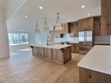 This stunning property features 4 bdrms, 4.5 bathrooms, and an on Teton Reserve in Idaho - for sale on GolfHomes.com, golf home, golf lot