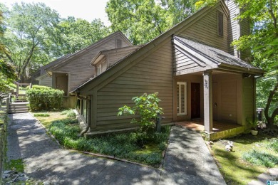 This home sits nestled in a wooded setting and water vista view on Inverness Country Club in Alabama - for sale on GolfHomes.com, golf home, golf lot