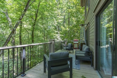 This home sits nestled in a wooded setting and water vista view on Inverness Country Club in Alabama - for sale on GolfHomes.com, golf home, golf lot
