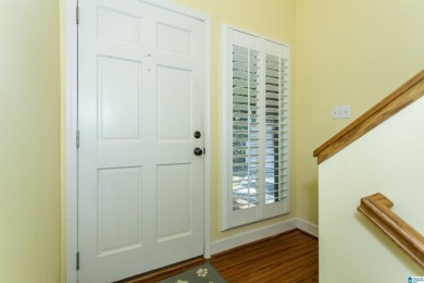 This home sits nestled in a wooded setting and water vista view on Inverness Country Club in Alabama - for sale on GolfHomes.com, golf home, golf lot