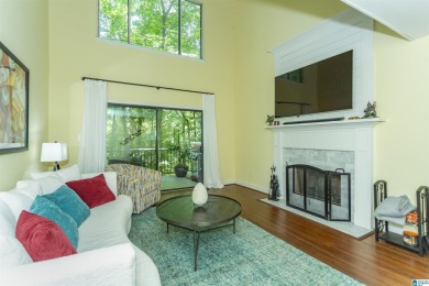 This home sits nestled in a wooded setting and water vista view on Inverness Country Club in Alabama - for sale on GolfHomes.com, golf home, golf lot