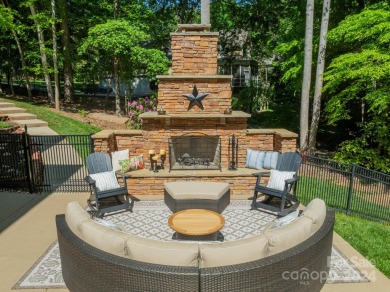 Step into your dream lake lifestyle this summer with this on Trump National Golf Club Charlotte in North Carolina - for sale on GolfHomes.com, golf home, golf lot