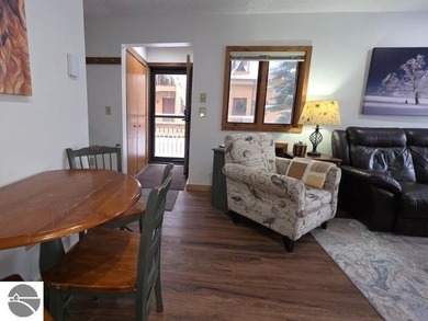 Comfortable in all seasons, this 2-bedroom condominium has on  in Michigan - for sale on GolfHomes.com, golf home, golf lot