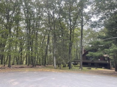 Tucked at the end of a quiet cul-de-sac and overlooking a on Paupack Hills Golf and Country Club in Pennsylvania - for sale on GolfHomes.com, golf home, golf lot