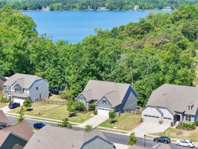 Experience lakefront living in this stunning 4-bedroom, 3.5-bath on The Palisades Country Club in North Carolina - for sale on GolfHomes.com, golf home, golf lot