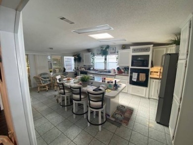 Discover this stunning triple-wide manufactured home in on Schalamar Creek Golf and Country Club in Florida - for sale on GolfHomes.com, golf home, golf lot