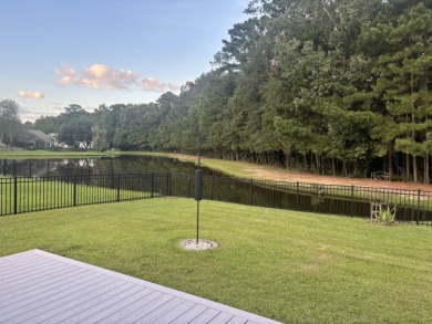 Imagine morning coffee on your back deck. Stillness. The pond on Charleston National Golf Club in South Carolina - for sale on GolfHomes.com, golf home, golf lot