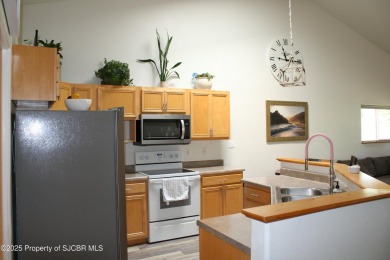 This cozy home features vaulted ceilings, a fireplace, and a 2 on San Juan Country Club in New Mexico - for sale on GolfHomes.com, golf home, golf lot