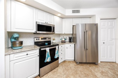 Discover luxury living in this stunning corner condo featuring on East Bay Golf Club in Florida - for sale on GolfHomes.com, golf home, golf lot