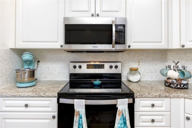 Discover luxury living in this stunning corner condo featuring on East Bay Golf Club in Florida - for sale on GolfHomes.com, golf home, golf lot