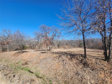 Nice level cleared off half acre lot with mature oak trees on Nocona Hills Golf Course in Texas - for sale on GolfHomes.com, golf home, golf lot