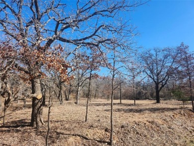 Nice level cleared off half acre lot with mature oak trees on Nocona Hills Golf Course in Texas - for sale on GolfHomes.com, golf home, golf lot
