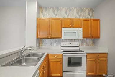 Welcome to this beautifully updated upper-level 2-bedroom on The Captains Club At Woodfield in Michigan - for sale on GolfHomes.com, golf home, golf lot