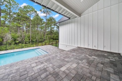This stunning NEW CONSTRUCTION home Wild Heron is a single level on Sharks Tooth Golf Club in Florida - for sale on GolfHomes.com, golf home, golf lot