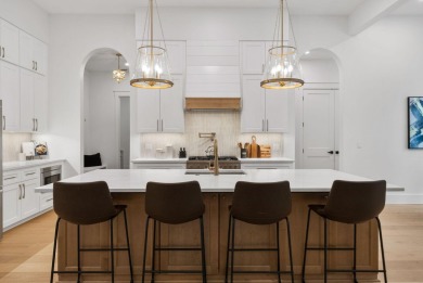 This stunning NEW CONSTRUCTION home Wild Heron is a single level on Sharks Tooth Golf Club in Florida - for sale on GolfHomes.com, golf home, golf lot