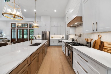 This stunning NEW CONSTRUCTION home Wild Heron is a single level on Sharks Tooth Golf Club in Florida - for sale on GolfHomes.com, golf home, golf lot