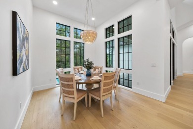 This stunning NEW CONSTRUCTION home Wild Heron is a single level on Sharks Tooth Golf Club in Florida - for sale on GolfHomes.com, golf home, golf lot