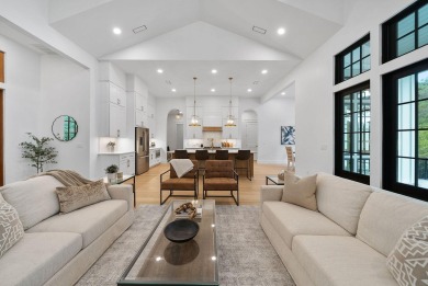 This stunning NEW CONSTRUCTION home Wild Heron is a single level on Sharks Tooth Golf Club in Florida - for sale on GolfHomes.com, golf home, golf lot