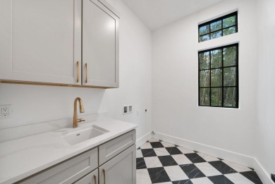 This stunning NEW CONSTRUCTION home Wild Heron is a single level on Sharks Tooth Golf Club in Florida - for sale on GolfHomes.com, golf home, golf lot