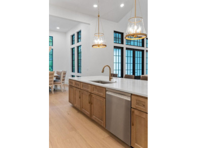 This stunning NEW CONSTRUCTION home Wild Heron is a single level on Sharks Tooth Golf Club in Florida - for sale on GolfHomes.com, golf home, golf lot