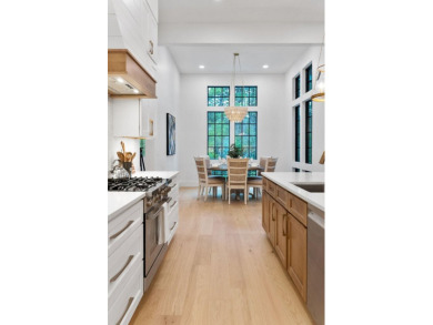 This stunning NEW CONSTRUCTION home Wild Heron is a single level on Sharks Tooth Golf Club in Florida - for sale on GolfHomes.com, golf home, golf lot