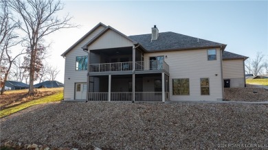 This exceptional residence has a wall of windows providing a on Osage National Golf Club in Missouri - for sale on GolfHomes.com, golf home, golf lot