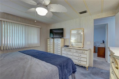 Your Resort-Style Oasis Awaits at 113 Royal Palms Circle, Largo on Palm Hill Golf Club in Florida - for sale on GolfHomes.com, golf home, golf lot