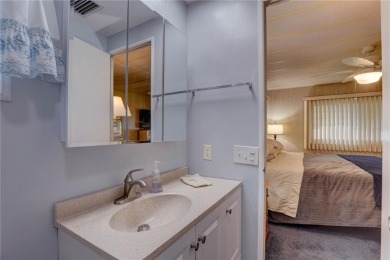 Your Resort-Style Oasis Awaits at 113 Royal Palms Circle, Largo on Palm Hill Golf Club in Florida - for sale on GolfHomes.com, golf home, golf lot