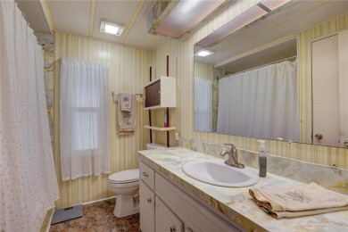 Your Resort-Style Oasis Awaits at 113 Royal Palms Circle, Largo on Palm Hill Golf Club in Florida - for sale on GolfHomes.com, golf home, golf lot