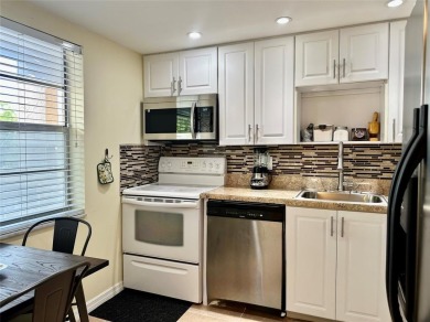 Discover easy South Florida living in this beautifully updated on Oriole Golf and Tennis Club in Florida - for sale on GolfHomes.com, golf home, golf lot